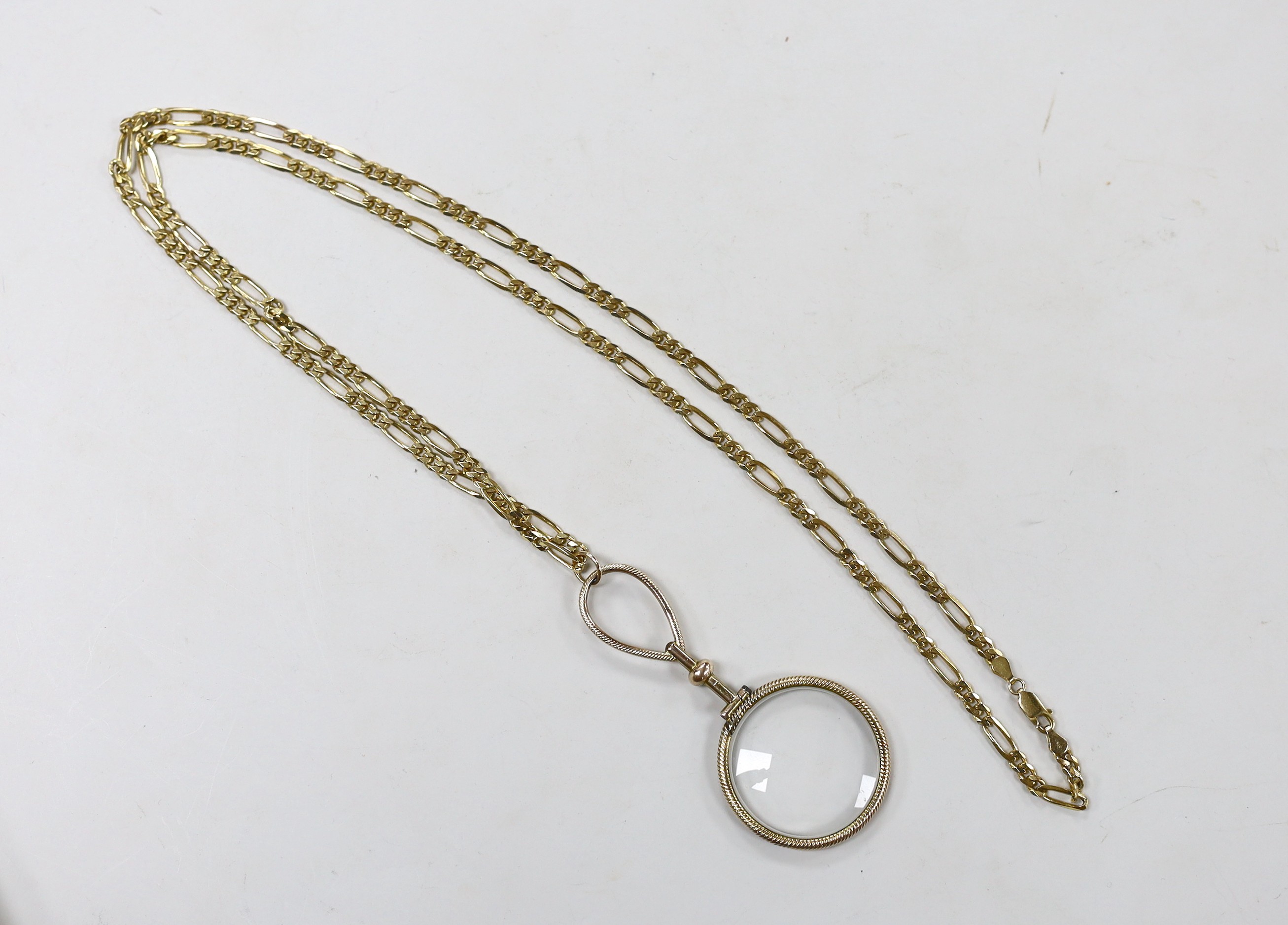 A yellow metal mounted eye glass, 85mm, suspended from a chain marked 375, 29.3 grams, 84cm.